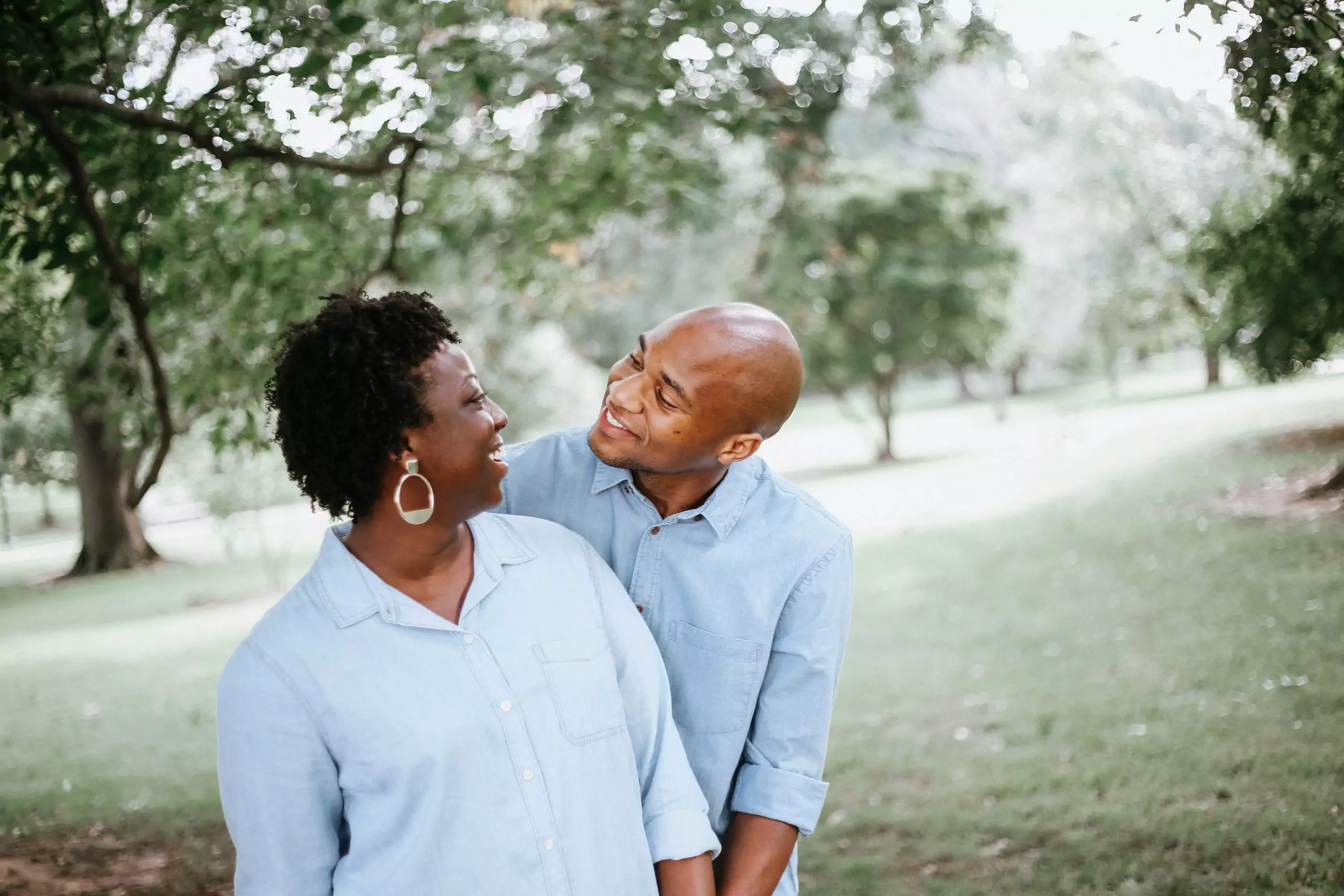 Middle age black couple smiling and holding one another at risk for glaucoma